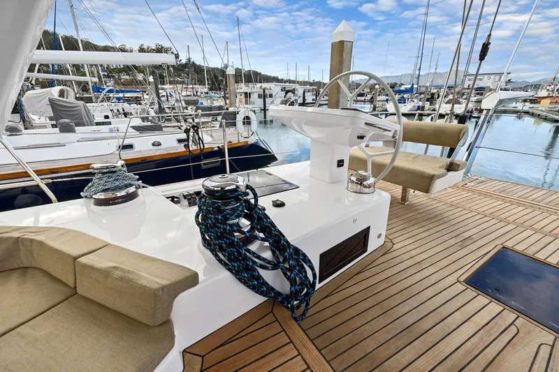 No Retreat Yacht Photos Pics Luxurious 2020 Hylas H57 yacht deck with steering wheel and marina view.