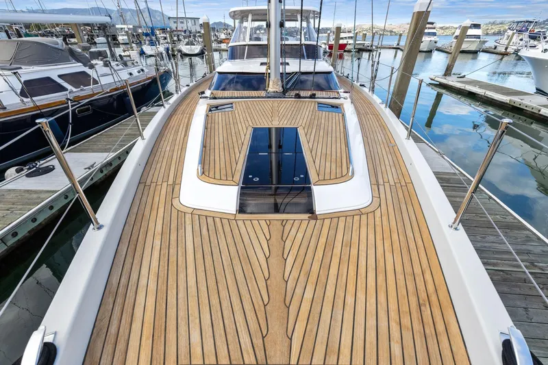 No Retreat Yacht Photos Pics Luxurious 2020 Hylas H57 yacht with sleek wooden deck, docked in a marina.