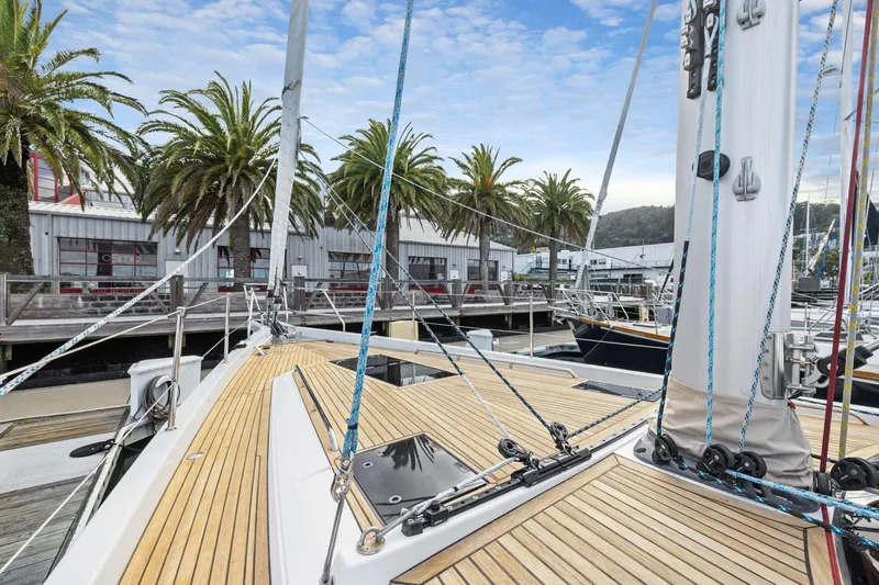 No Retreat Yacht Photos Pics Deck view of 2020 Hylas H57 yacht docked near palm trees and marina.