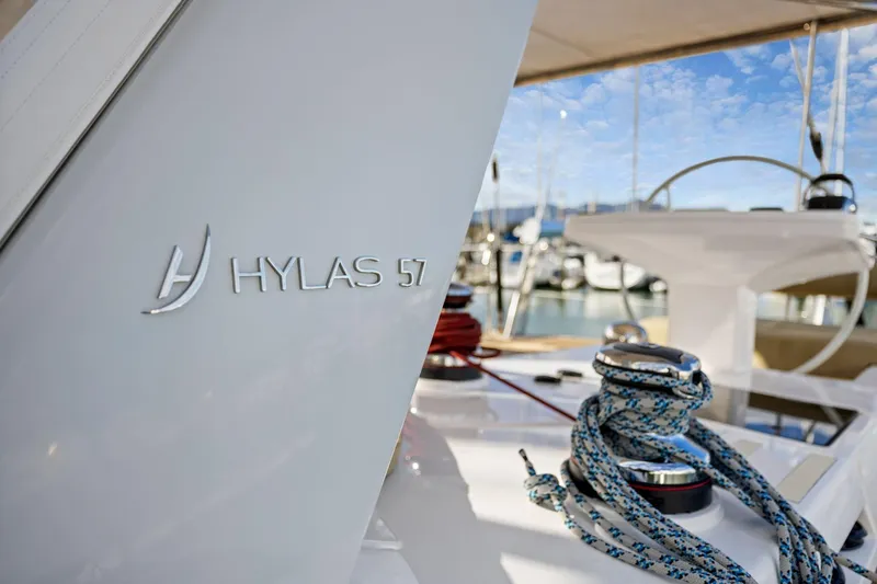No Retreat Yacht Photos Pics 2020 Hylas H57 yacht deck with ropes and steering wheel in marina.