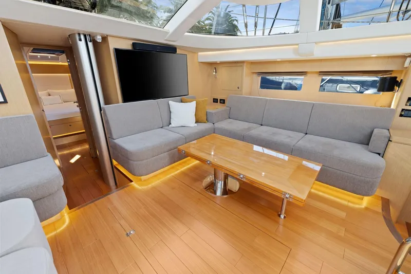 No Retreat Yacht Photos Pics Luxurious interior of 2020 Hylas H57 yacht with modern seating and wooden flooring.