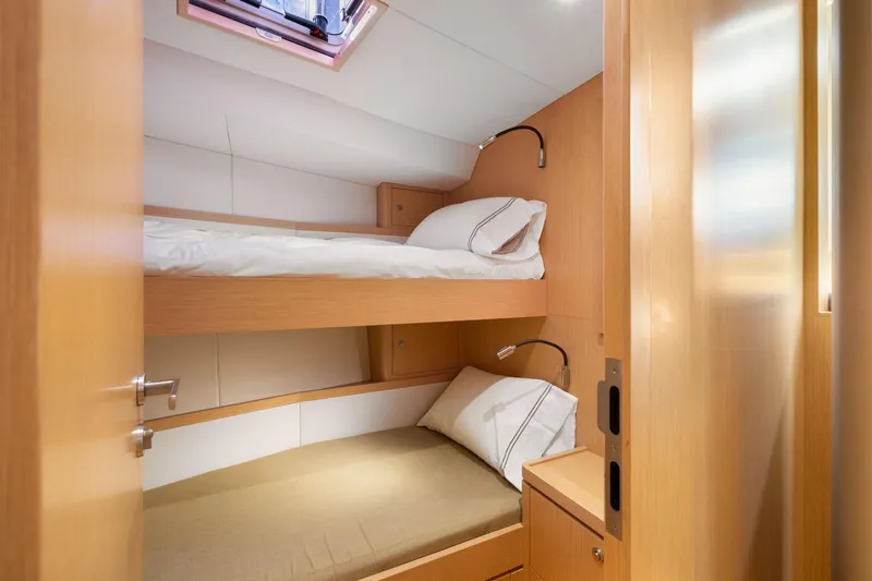 No Retreat Yacht Photos Pics Cozy bunk beds in 2020 Hylas H57 yacht cabin with natural wood finish.