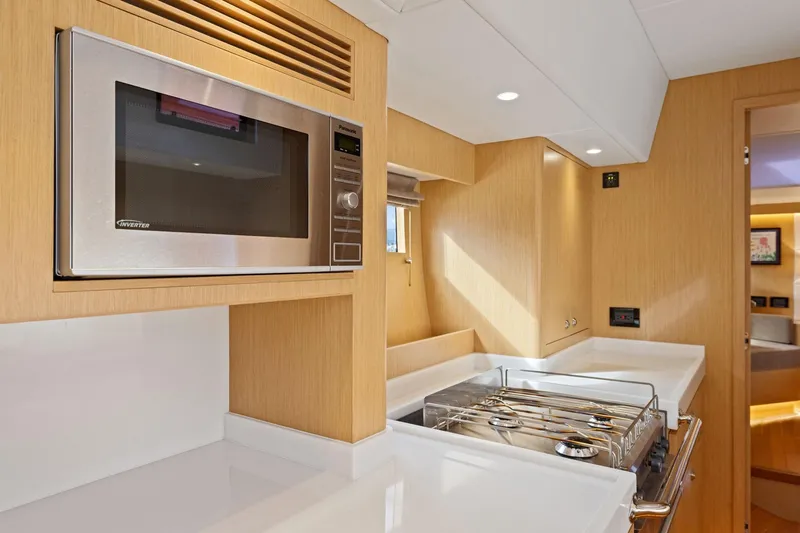 No Retreat Yacht Photos Pics Modern kitchen in 2020 Hylas H57 yacht with microwave and stove.