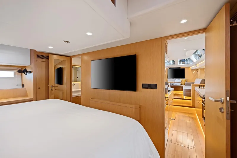 No Retreat Yacht Photos Pics Luxurious interior of 2020 Hylas H57 yacht featuring modern bedroom and living area.