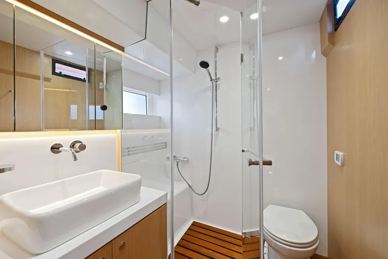 No Retreat Yacht Photos Pics Modern bathroom in 2020 Hylas H57 yacht with sleek fixtures and wooden accents.