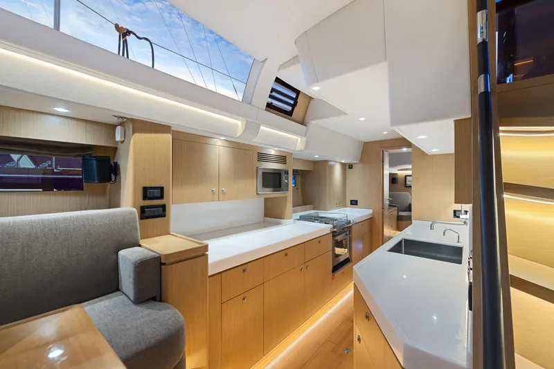 No Retreat Yacht Photos Pics Luxurious interior of 2020 Hylas H57 yacht featuring modern kitchen and seating area.