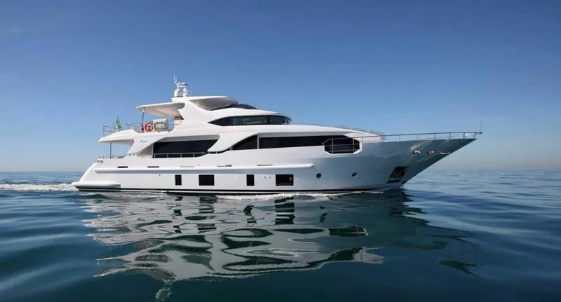  Yacht Photos Pics 2013 Benetti Delfino 93 yacht cruising on calm waters under a clear blue sky.