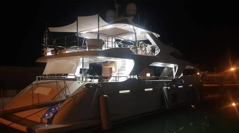  Yacht Photos Pics Luxurious 2013 Benetti Delfino 93 yacht illuminated at night in a marina.