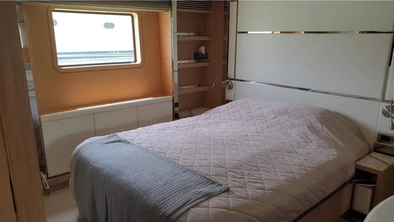  Yacht Photos Pics Luxurious bedroom on a 2013 Benetti Delfino 93 yacht with a large window.