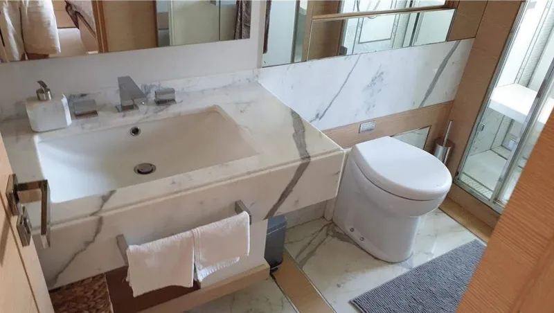 Yacht Photos Pics Luxurious bathroom in a 2013 Benetti Delfino 93 yacht with marble sink and modern fixtures.