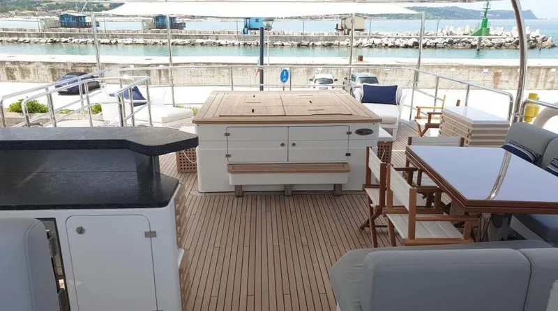  Yacht Photos Pics 2013 Benetti Delfino 93 yacht deck with seating and dining area.