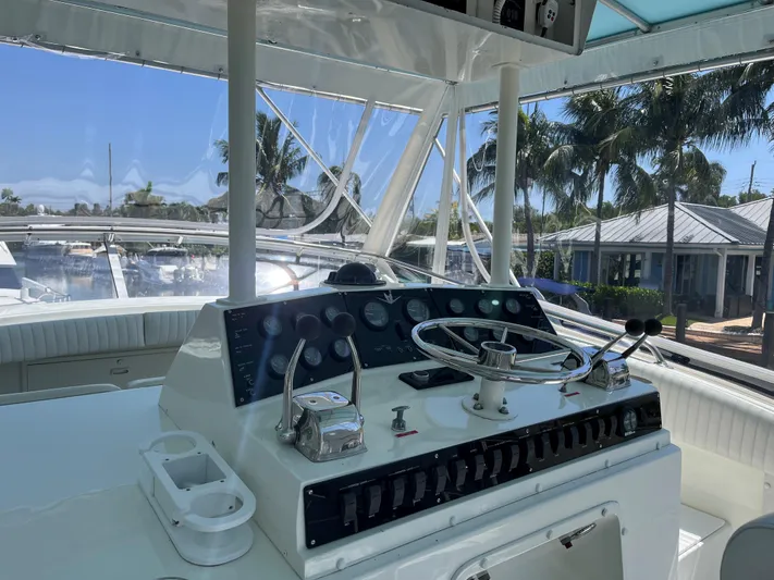 Laid Back Yacht Photos Pics Helm of 1983 Bertram 46 Convertible yacht with steering wheel and controls.