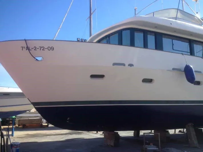  Yacht Photos Pics Luxury yacht ABD 60, 2006 model, docked for maintenance under clear blue sky.