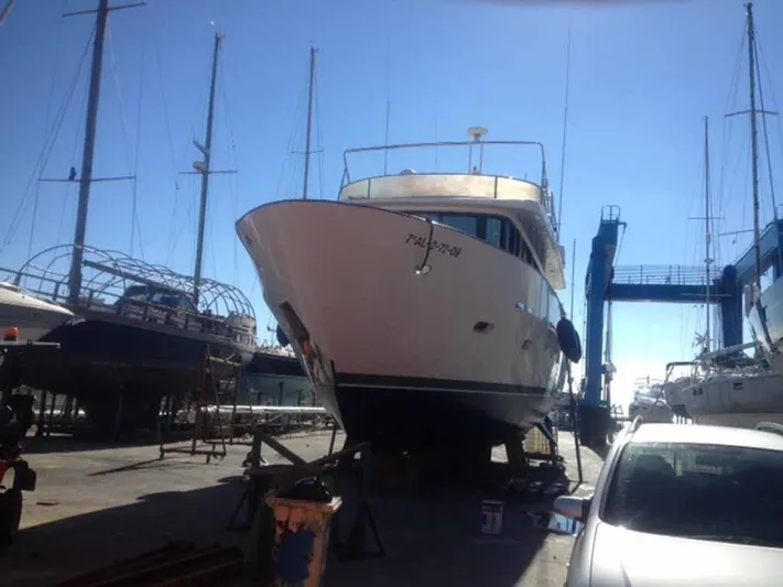  Yacht Photos Pics A 2006 ABD 60 yacht on dry dock under clear blue sky.