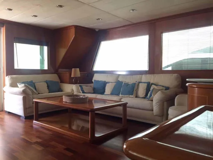  Yacht Photos Pics Luxurious yacht interior with plush seating, wooden accents, and large windows, ABD 60, 2006 model.