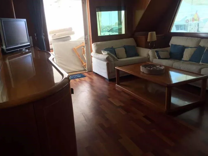  Yacht Photos Pics Luxurious yacht interior with wooden flooring, cozy seating, and a TV, model ABD 60, 2006.