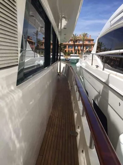  Yacht Photos Pics Side deck of 2006 ABD 60 yacht with wooden flooring and marina view.