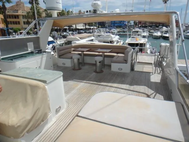  Yacht Photos Pics Luxurious 2006 ABD 60 yacht deck with seating area in a marina.