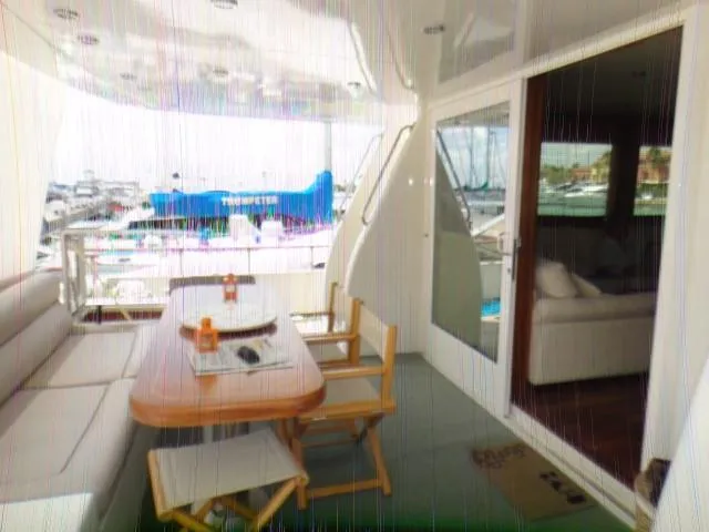  Yacht Photos Pics Luxurious yacht deck with seating area, table, and marina view, ABD 60, 2006 model.