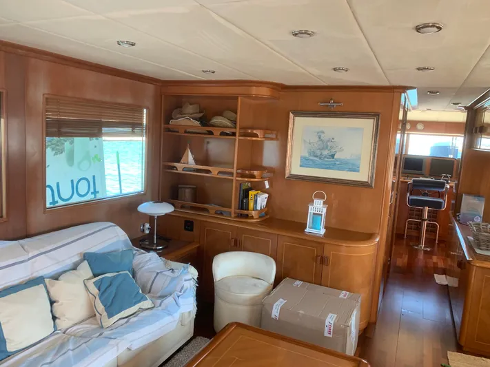  Yacht Photos Pics Luxurious 2006 ABD 60 yacht interior with cozy seating, wooden shelves, and nautical decor.