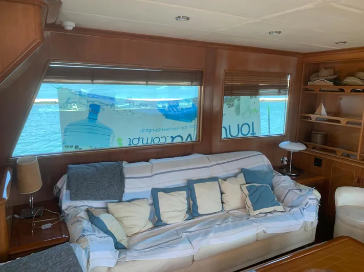  Yacht Photos Pics Luxurious yacht interior with cozy sofa, cushions, and ocean view through large windows. ABD 60, 2006.