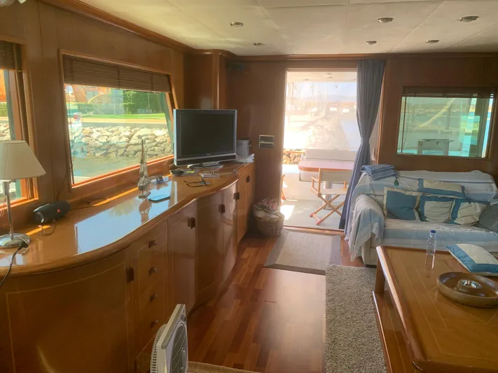  Yacht Photos Pics Luxurious 2006 ABD 60 yacht interior with wood finish, cozy seating, and large windows.