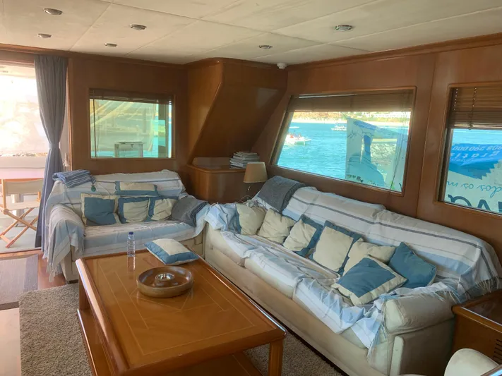  Yacht Photos Pics Luxurious yacht interior with cozy sofas, wooden table, and scenic ocean view. ABD 60, 2006 model.