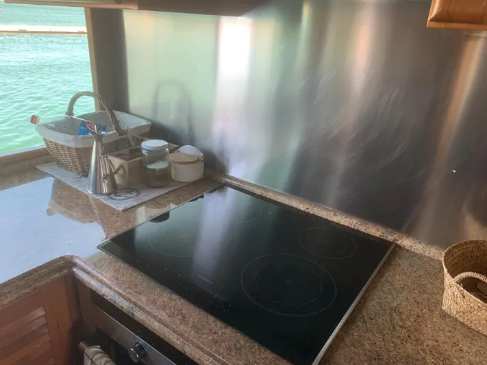  Yacht Photos Pics Modern kitchen with electric cooktop, granite countertops, and ocean view on ABD 60 yacht.