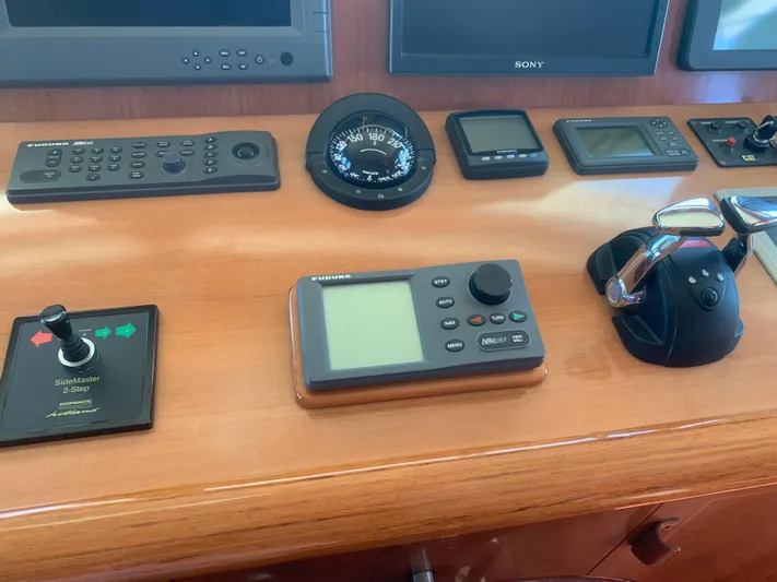  Yacht Photos Pics Control panel of a 2006 ABD 60 yacht with navigation instruments and throttle controls.