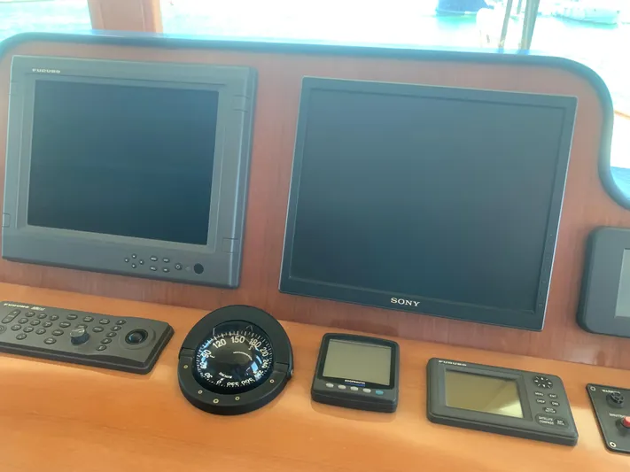  Yacht Photos Pics Control panel with navigation screens and compass on ABD 60, 2006 model.