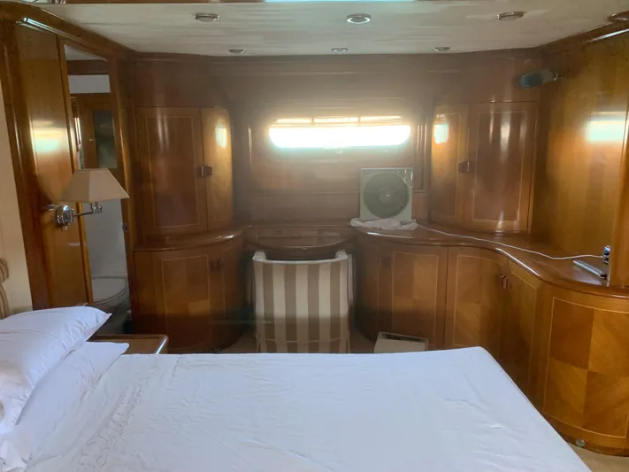  Yacht Photos Pics Luxurious yacht cabin with wooden interior, featuring a bed and striped chair, ABD 60, 2006 model.
