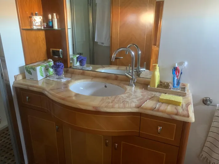  Yacht Photos Pics Luxurious bathroom with marble countertop, modern sink, and wooden cabinetry in ABD 60, 2006 model.