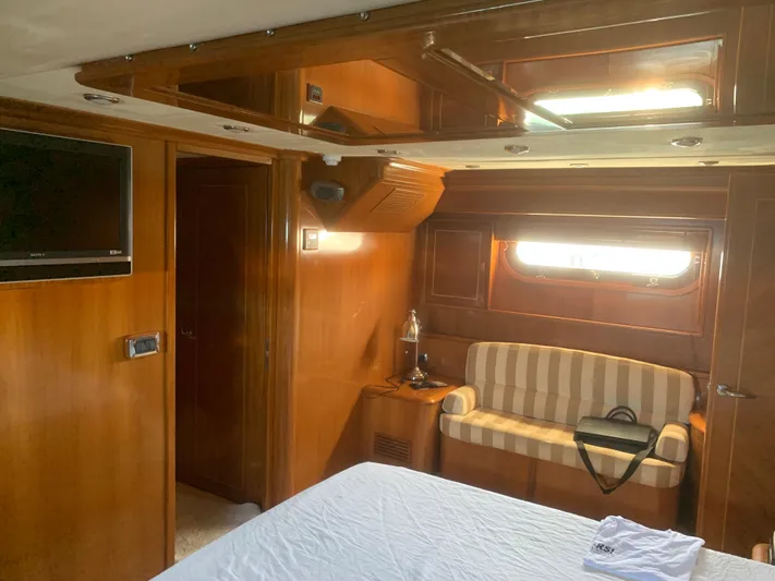  Yacht Photos Pics Luxurious cabin interior of 2006 ABD 60 yacht with wood paneling and striped sofa.