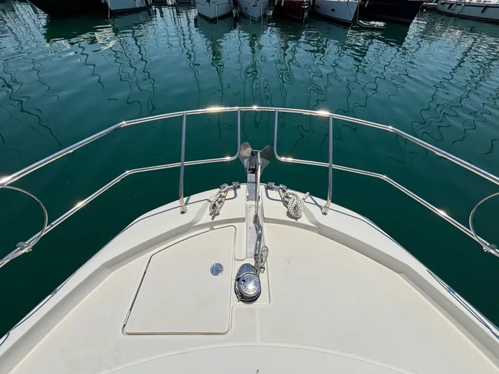  Yacht Photos Pics Bow view of 2020 Jeanneau Prestige 420 Flybridge yacht in marina.