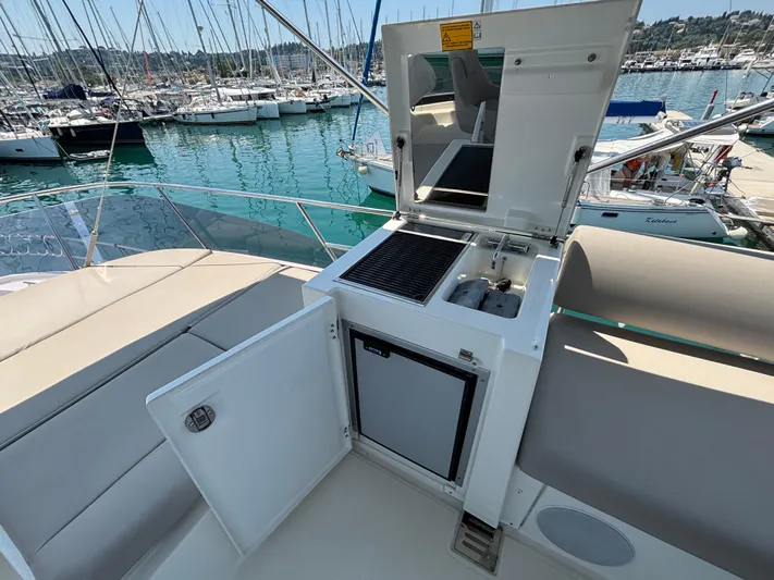  Yacht Photos Pics Flybridge of 2020 Jeanneau Prestige 420 with open kitchenette, overlooking marina.