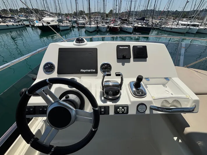  Yacht Photos Pics Flybridge helm of 2020 Jeanneau Prestige 420, featuring Raymarine electronics and steering wheel.