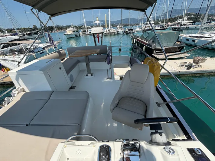  Yacht Photos Pics Flybridge of 2020 Jeanneau Prestige 420 yacht, featuring helm seat and spacious seating area.