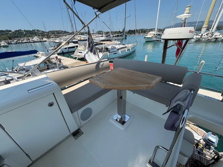  Yacht Photos Pics Flybridge seating area on 2020 Jeanneau Prestige 420, overlooking marina with sailboats.