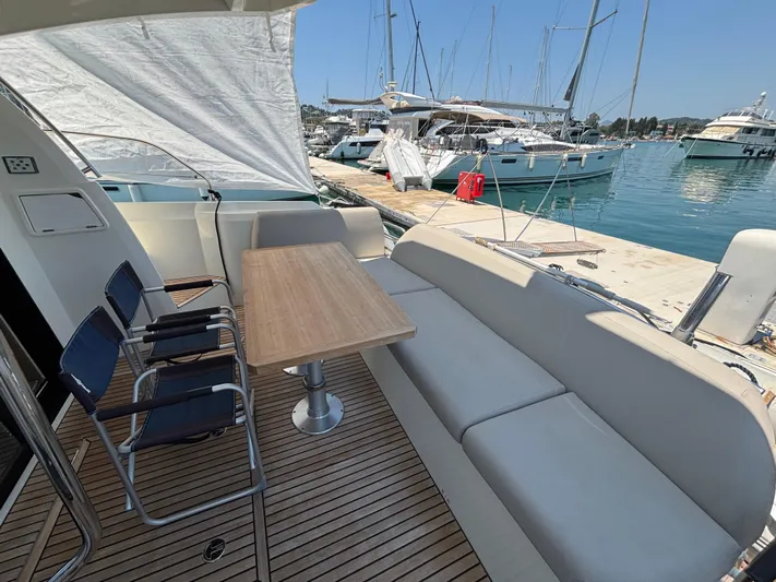  Yacht Photos Pics Flybridge seating area on 2020 Jeanneau Prestige 420, docked at marina with sailboats.