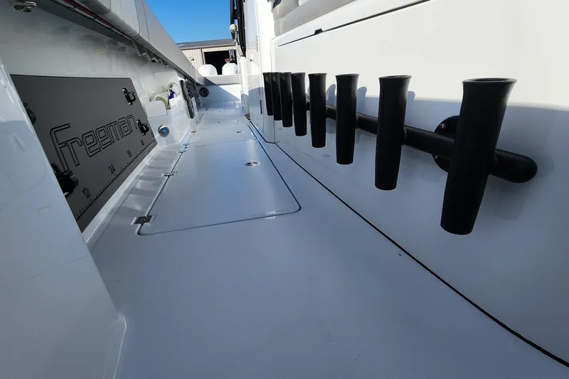 Arrogant 1 Yacht Photos Pics 2022 Freeman 37 Center Console boat interior with rod holders and storage compartments.