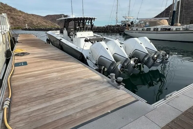 Arrogant 1 Yacht Photos Pics 2022 Freeman 37 Center Console boat docked with triple outboard engines.