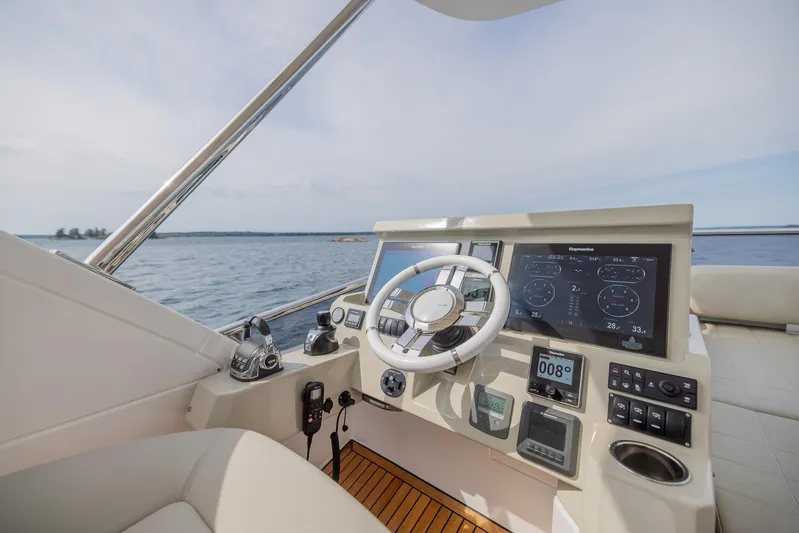  Yacht Photos Pics Azimut 50 Flybridge 2018 yacht helm with modern navigation controls on open water.