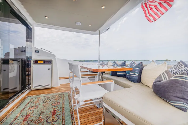  Yacht Photos Pics Luxurious 2018 Azimut 50 Flybridge yacht deck with seating, table, and American flag.