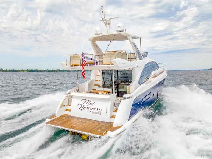  Yacht Photos Pics Azimut 50 Flybridge 2018 yacht cruising on open water, rear view.