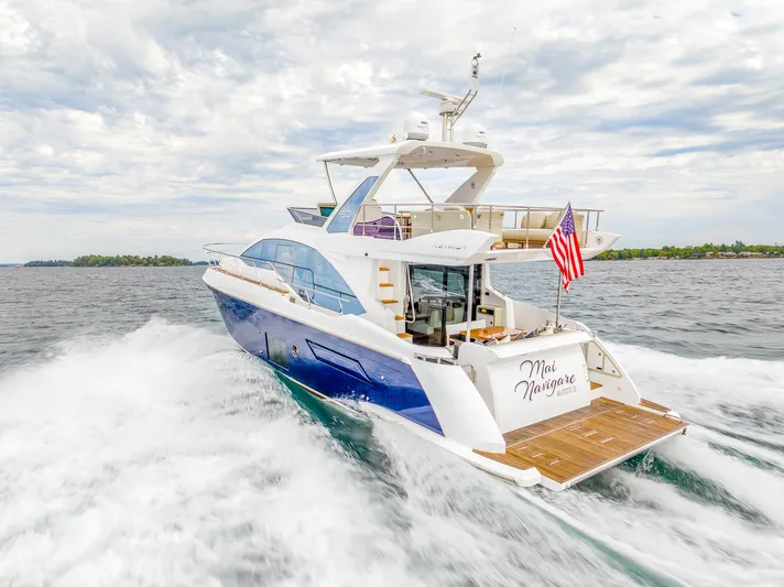  Yacht Photos Pics Azimut 50 Flybridge 2018 yacht cruising on open water, American flag displayed.
