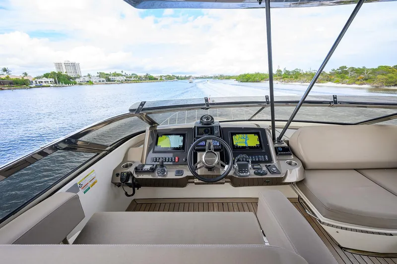 Andiamo Yacht Photos Pics Helm of 2016 Marquis 660 Sport Yacht with navigation screens and luxurious seating.