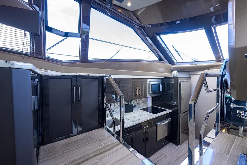 Andiamo Yacht Photos Pics Luxurious interior of 2016 Marquis 660 Sport Yacht with modern kitchen design.