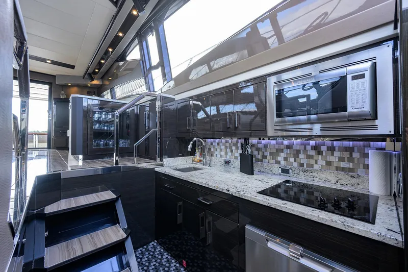 Andiamo Yacht Photos Pics Luxurious kitchen interior of 2016 Marquis 660 Sport Yacht with modern appliances and sleek design.