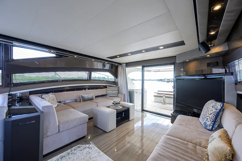 Andiamo Yacht Photos Pics Luxurious interior of 2016 Marquis 660 Sport Yacht with elegant seating and large windows.