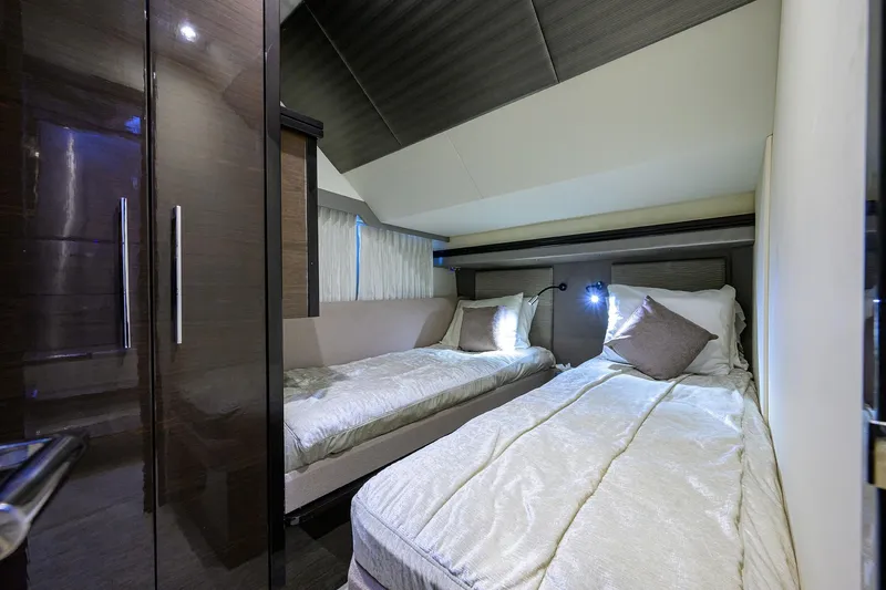 Andiamo Yacht Photos Pics Luxurious twin bedroom in 2016 Marquis 660 Sport Yacht, featuring modern design and cozy bedding.